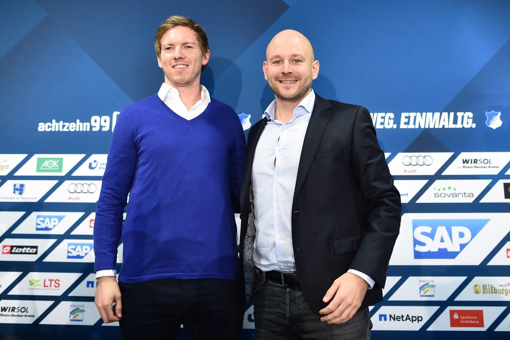 epa05156211 Julian Nagelsmann (L), new coach of German Bundesliga soccer club 1899 Hoffenheim, and Hoffenheim's sporting director Alexander Rosen pose at a press conference in Zuzenhausen, Germany, 12 February 2016. 28-year-old Nagelsmann is to become the currently youngest coach of the German Bundesliga. EPA/UWE ANSPACH