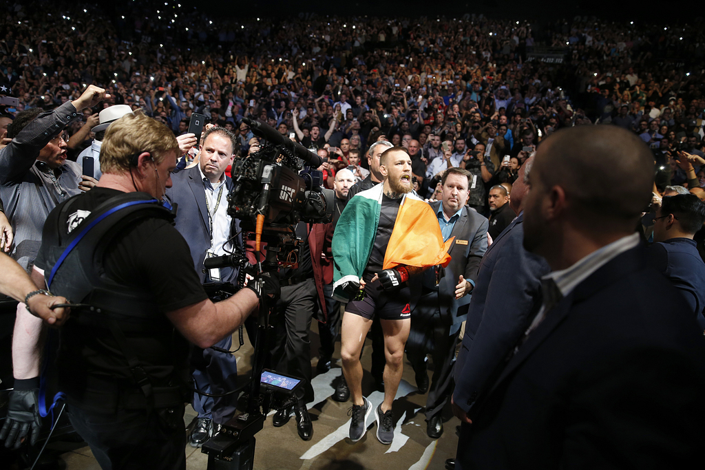 Conor McGregor walks toward the octagon just before his UFC 196 welterweight mixed martial arts match against Nate Diaz, Saturday, March 5, 2016, in Las Vegas. (AP Photo/Eric Jamison)