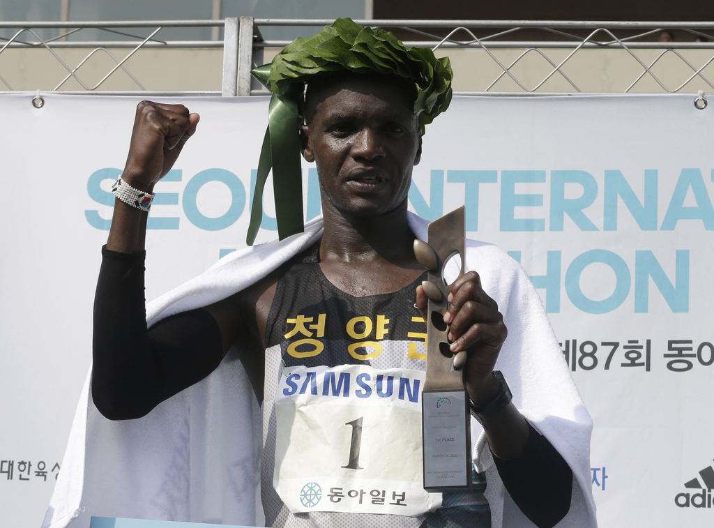 Wilson Loyanae Erupe of Kenya poses during the awarding ceremony after winning the men's race of the Seoul International Marathon at Olympic Stadium in Seoul, South Korea, Sunday, March 20, 2016. Defending champion Loyanae won the race with a time of 2 hours, 5 minutes, 13 seconds. (AP Photo/Ahn Young-joon)