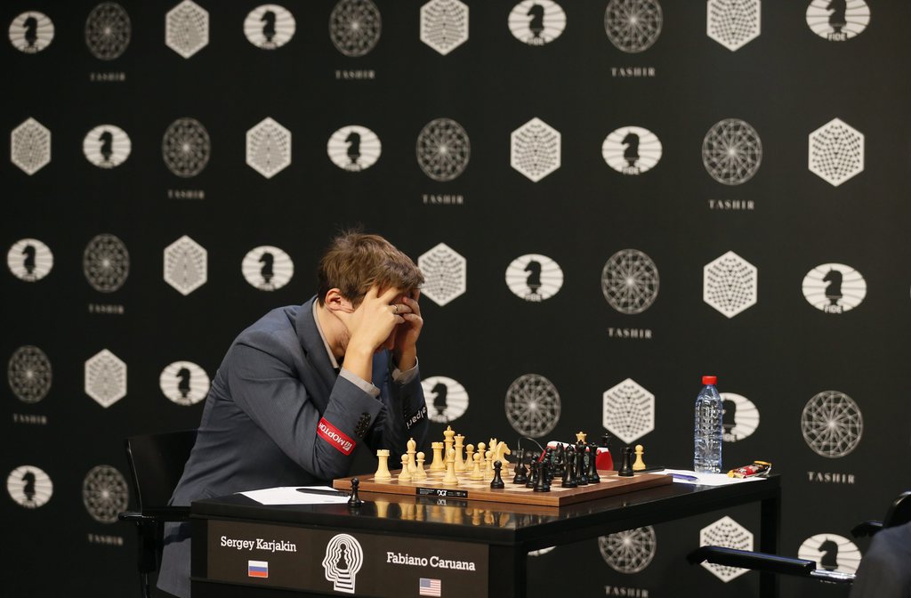 epa05233477 Sergey Karjakin of Russia plays against Fabiano Caruana (unseen) of the US during the FIDE World Chess Candidates Tournament in Moscow, Russia, 28 March 2016. The event which determines the next Challenger to Magnus Carlsen's title. EPA/SERGEI ILNITSKY