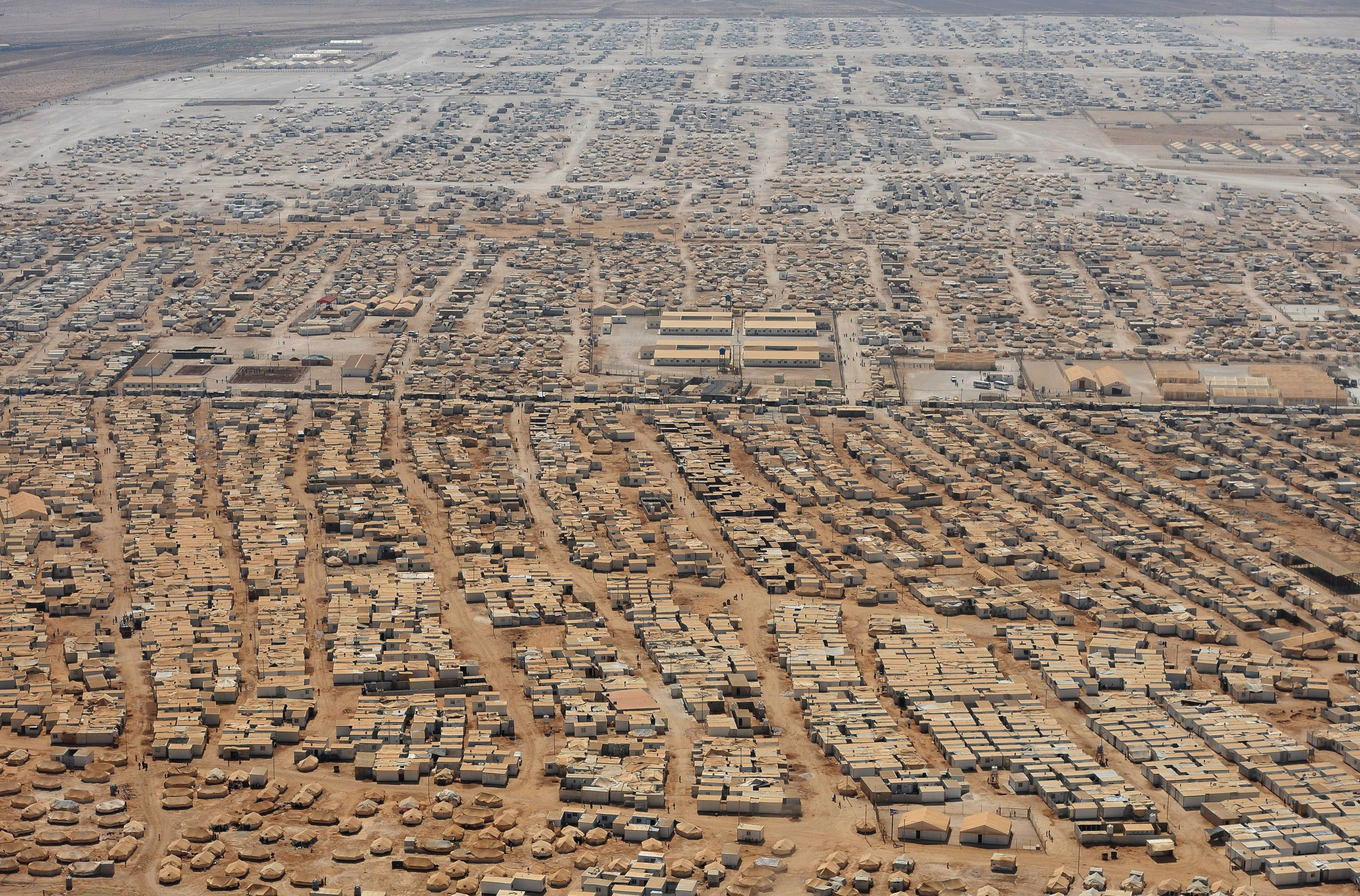 An aerial view shows the Zaatari refugee camp, near the Jordanian city of Mafraq July 18, 2013. U.S. Secretary of State John Kerry spent about 40 minutes with half a dozen refugees who vented their frustration at the international community's failure to end Syria's more than two-year-old civil war, while visiting the camp that holds roughly 115,000 Syrian refugees in Jordan about 12 km (eight miles) from the Syrian border. REUTERS/Mandel Ngan/Pool (JORDAN - Tags: POLITICS SOCIETY IMMIGRATION TPX IMAGES OF THE DAY) - RTX11QHF