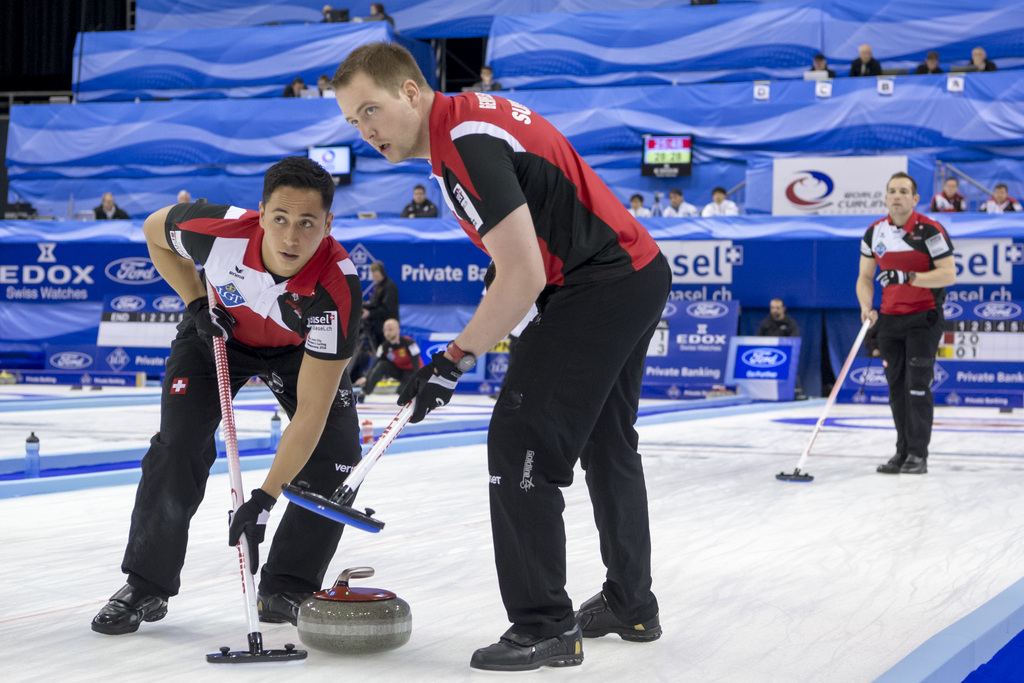 Switzerland's second Enrico Pfister, lead Simon Gempeler and skip Sven Michel, from left, in action during a round robin match between Switzerland and Sweden at the world men's curling championship 2016 in the St. Jakobshalle in Basel, Switzerland, on Sunday, April 3, 2016. (KEYSTONE/ Georgios Kefalas)