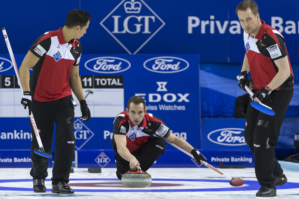 Switzerland's second Enrico Pfister, skip Sven Michel and lead Simon Gempeler, from left, in action during a round robin match between Switzerland and Korea at the world men's curling championship 2016 in the St. Jakobshalle in Basel, Switzerland, on Monday, April 4, 2016. (KEYSTONE/ Georgios Kefalas)