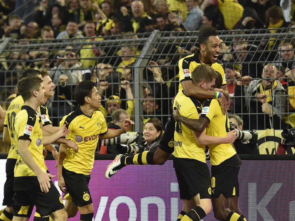 Dortmund's team celebrate after Adrian Ramos, right, scored the decisive goal during the German Bundesliga soccer match between Borussia Dortmund and Werder Bremen in Dortmund, Germany, Saturday, April 2, 2016. Dortmund defeated Bremen in a dramatic match with 3-2. (AP Photo/Martin Meissner)