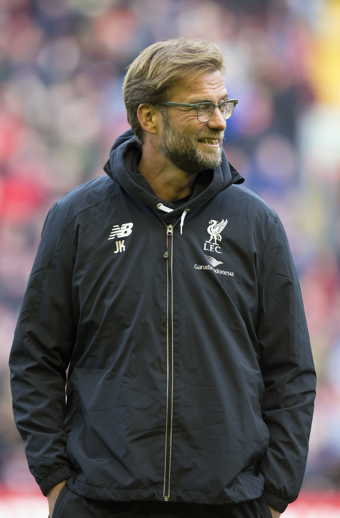 Liverpool's manager Juergen Klopp watches as his players warm up before the English Premier League soccer match between Liverpool and Tottenham Hotspur at Anfield Stadium, Liverpool, England, Saturday, April 2, 2016. (AP Photo/Jon Super)