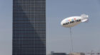 A blimp reading "Google must pay tax" is seen floating over the Tel Aviv skyline April 3, 2016. Israeli attorney Guy Ofir is 