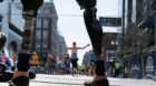 Celeste Corcoran, who lost both her legs in the Boston Marathon bombings, greets runners at they finish the120th running of t