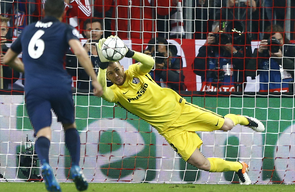Atletico goalkeeper Jan Oblak saves a Thomas Muller penalty during the Champions League second leg semifinal soccer match between Bayern Munich and Atletico de Madrid in Munich, Germany, Tuesday, May 3, 2016. (AP Photo/Matthias Schrader)