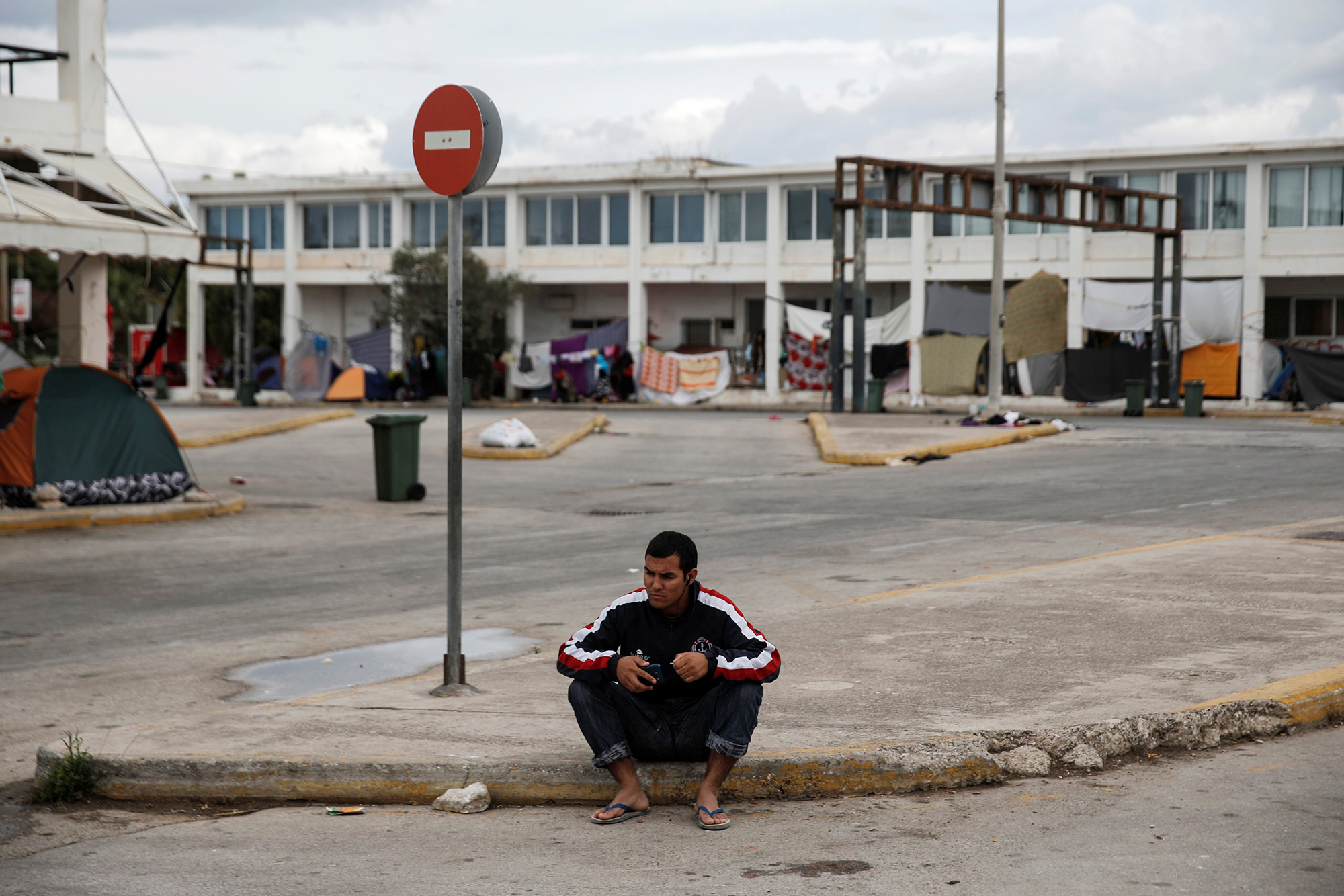 A migrant sits at the premises of the disused Hellenikon airport where stranded refugees and migrants, most of them Afghans, are temporarily accommodated in Athens, Greece, May 3, 2016. REUTERS/Alkis Konstantinidis