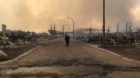 A Mountie surveys the damage on a street in Fort McMurray, Alberta, Canada in this May 4, 2016 image posted on social media. 