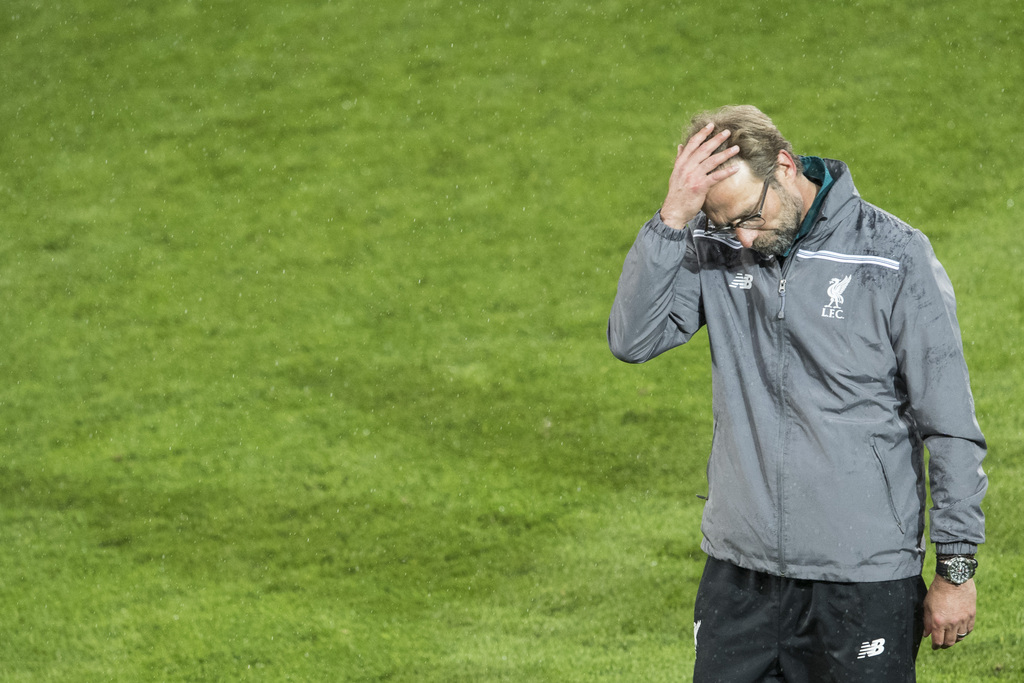 Liverpool's head coach Juergen Klopp touches his head after the soccer Europa League final between England's Liverpool FC and Spain's Sevilla Futbol Club at the St. Jakob-Park stadium in Basel, Switzerland, on Wednesday, May 18, 2016. (Ennio Leanza/Keystone via AP)