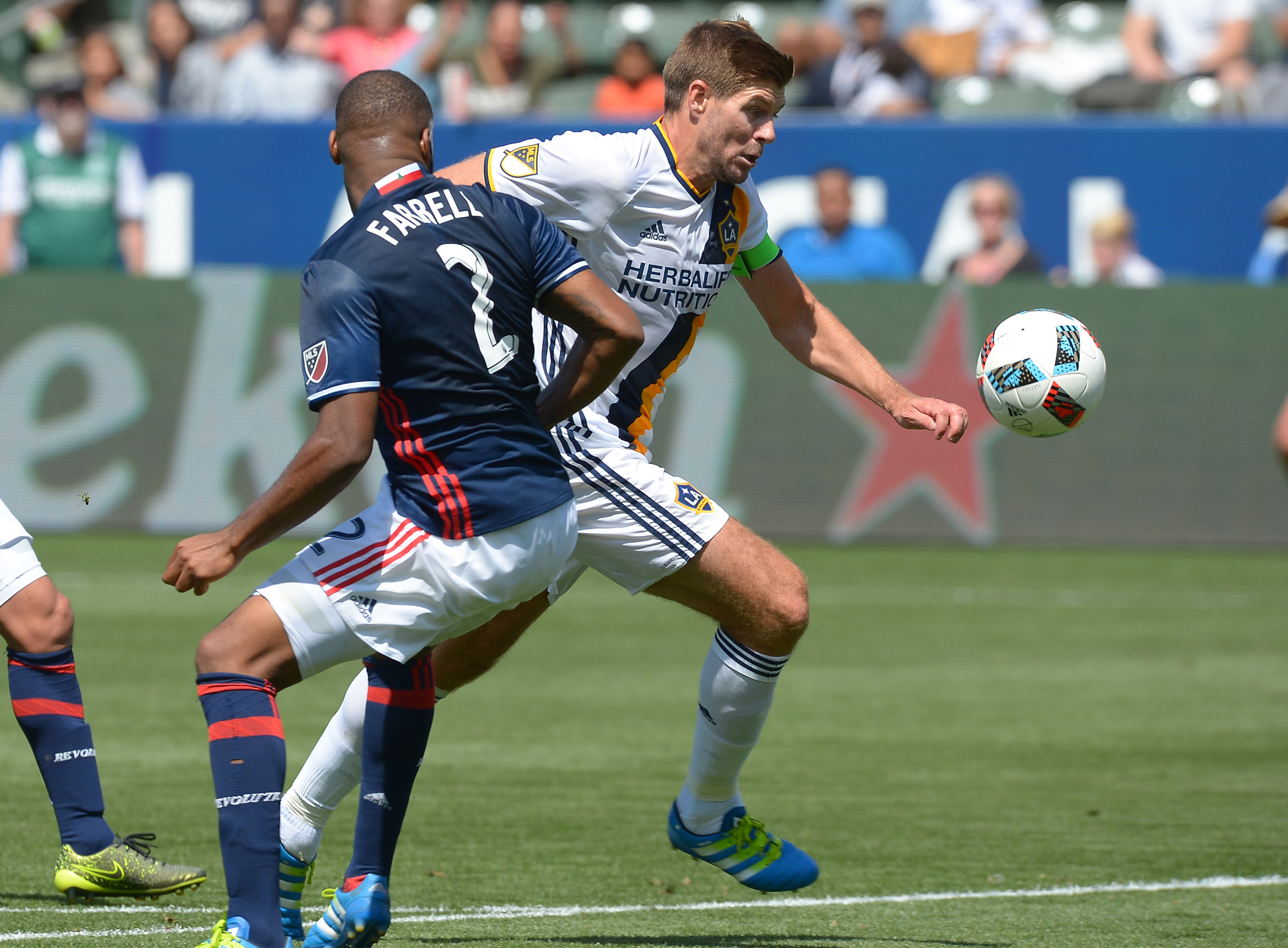 May 8, 2016; Carson, CA, USA; Los Angeles Galaxy midfielder Steven Gerrard (8) dribbles the ball past New England Revolution defender Andrew Farrell (2) to score a goal in the second half at StubHub Center. Galaxy won 4-2. Mandatory Credit: Jayne Kamin-Oncea-USA TODAY Sports