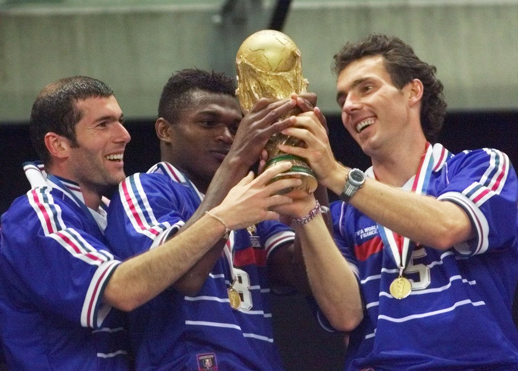 French teammates from left : Zinedine Zidane, Marcel Desailly and Laurent Blanc hold the World Cup after France defeated Brazil 3-0 in the final of the World Cup 98at the Stade de France in Saint Denis, north of Paris, Sunday, July 12, 1998. (AP Photo/Michel Euler)