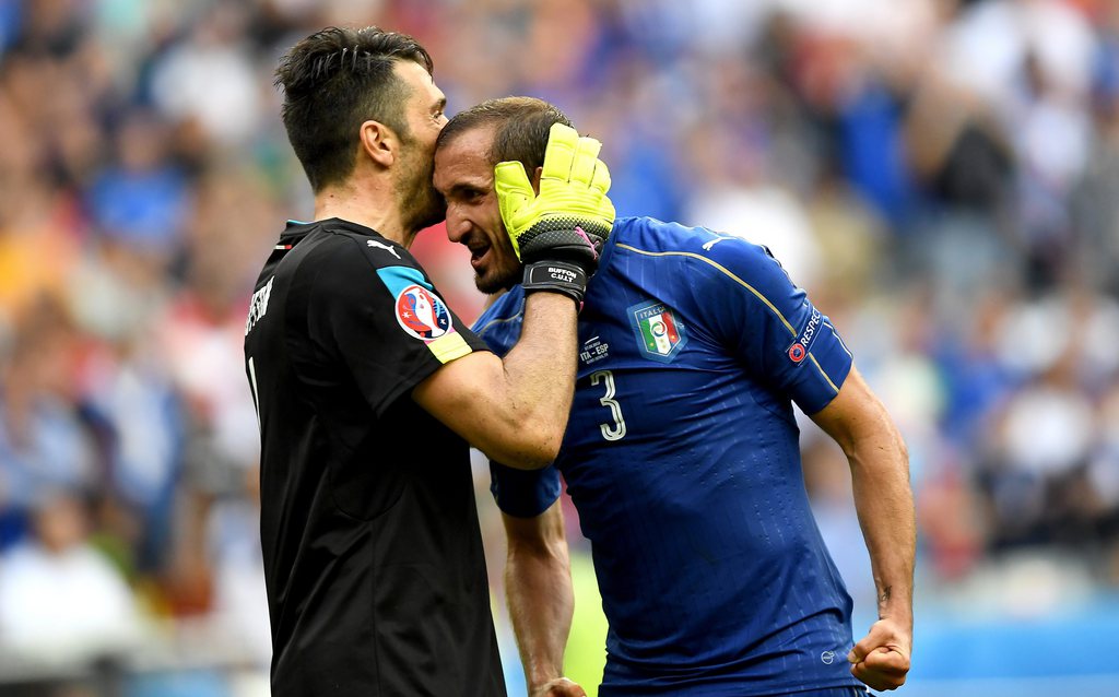 epa05394956 Goalkeeper Gianluigi Buffon of Italy (L) and Giorgio Chiellini of Italy react after the UEFA EURO 2016 round of 16 match between Italy and Spain at Stade de France in St. Denis, France, 27 June 2016. ....(RESTRICTIONS APPLY: For editorial news reporting purposes only. Not used for commercial or marketing purposes without prior written approval of UEFA. Images must appear as still images and must not emulate match action video footage. Photographs published in online publications (whether via the Internet or otherwise) shall have an interval of at least 20 seconds between the posting.) EPA/GEORGI LICOVSKI EDITORIAL USE ONLY