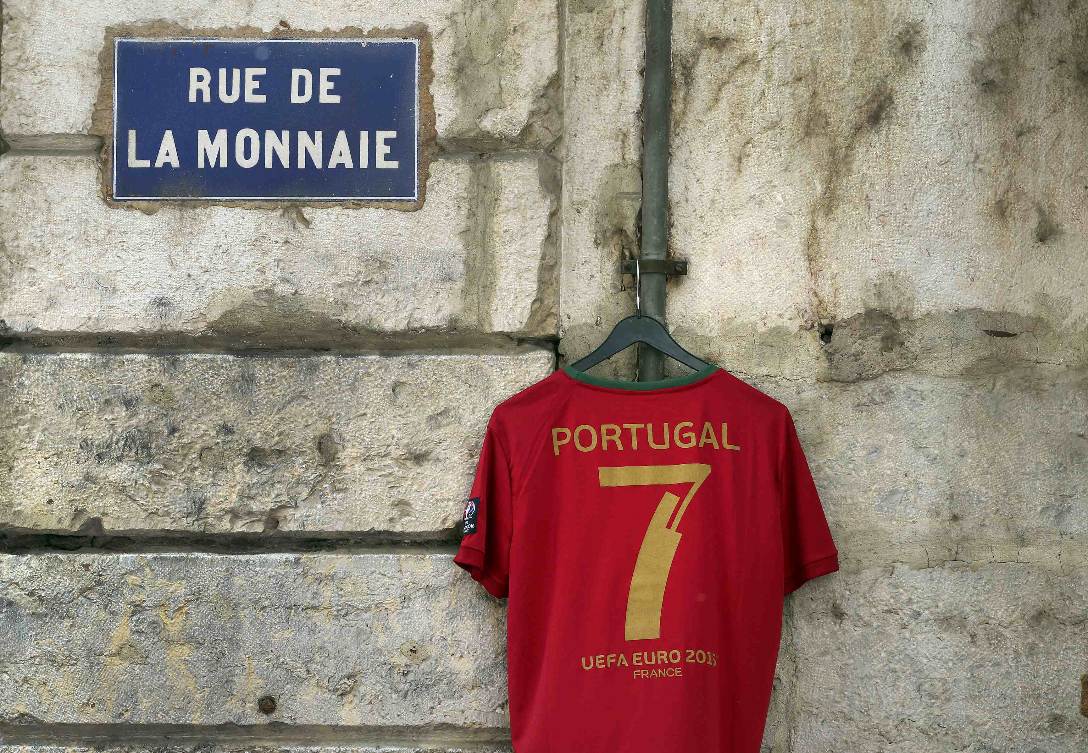 Football Soccer - Wales v Portugal - Euro 2016 - Semi final - Lyon, France - 6/7/16 - A Portugal team T-shirt for sale is seen hanging outside a cafe in Lyon before the semi-final against Wales. REUTERS/Stefano Rellandini