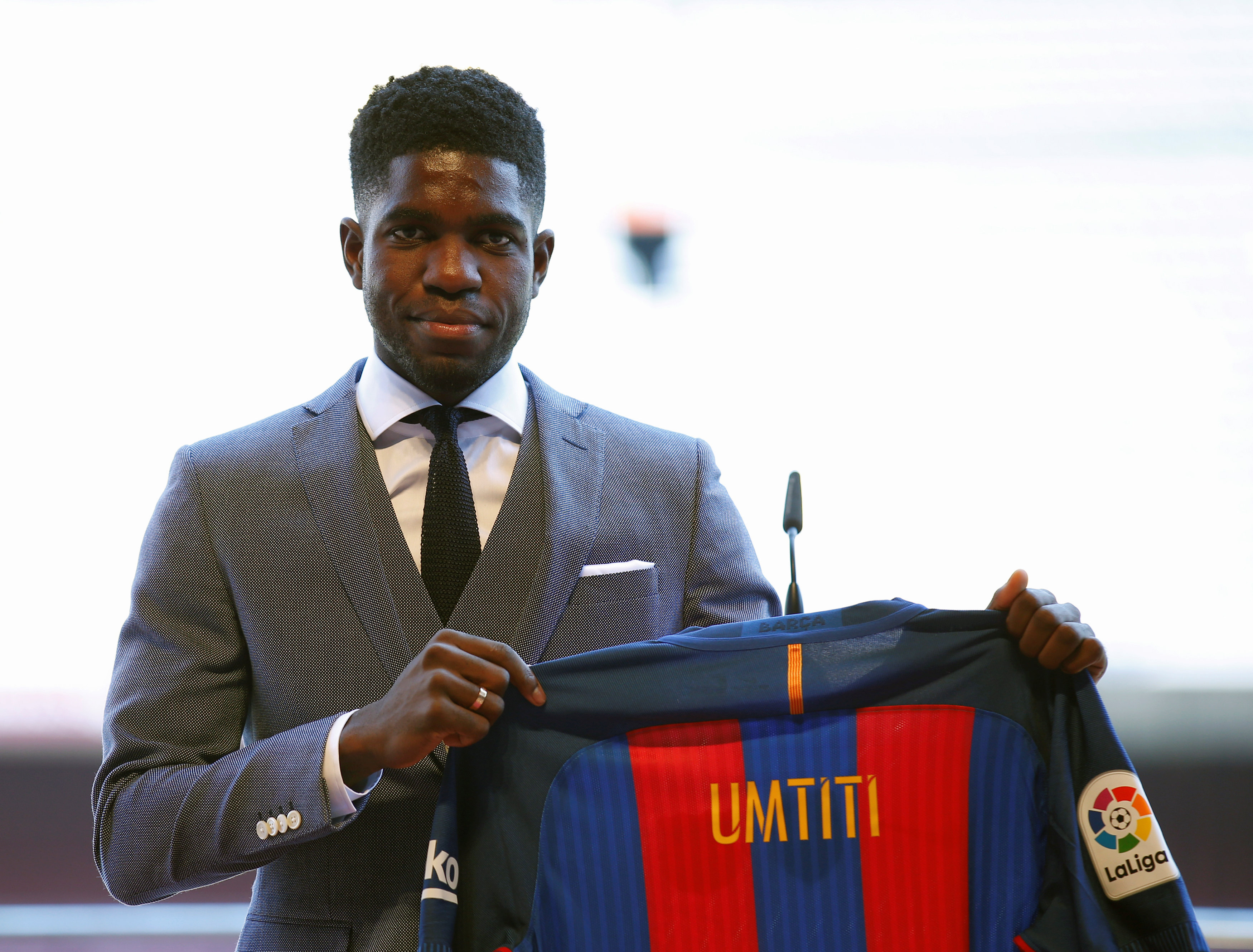 FC Barcelona's newly signed soccer player Samuel Umtiti poses with his new jersey during his presentation at Camp Nou stadium in Barcelona, Spain, July 15, 2016. REUTERS/Albert Gea
