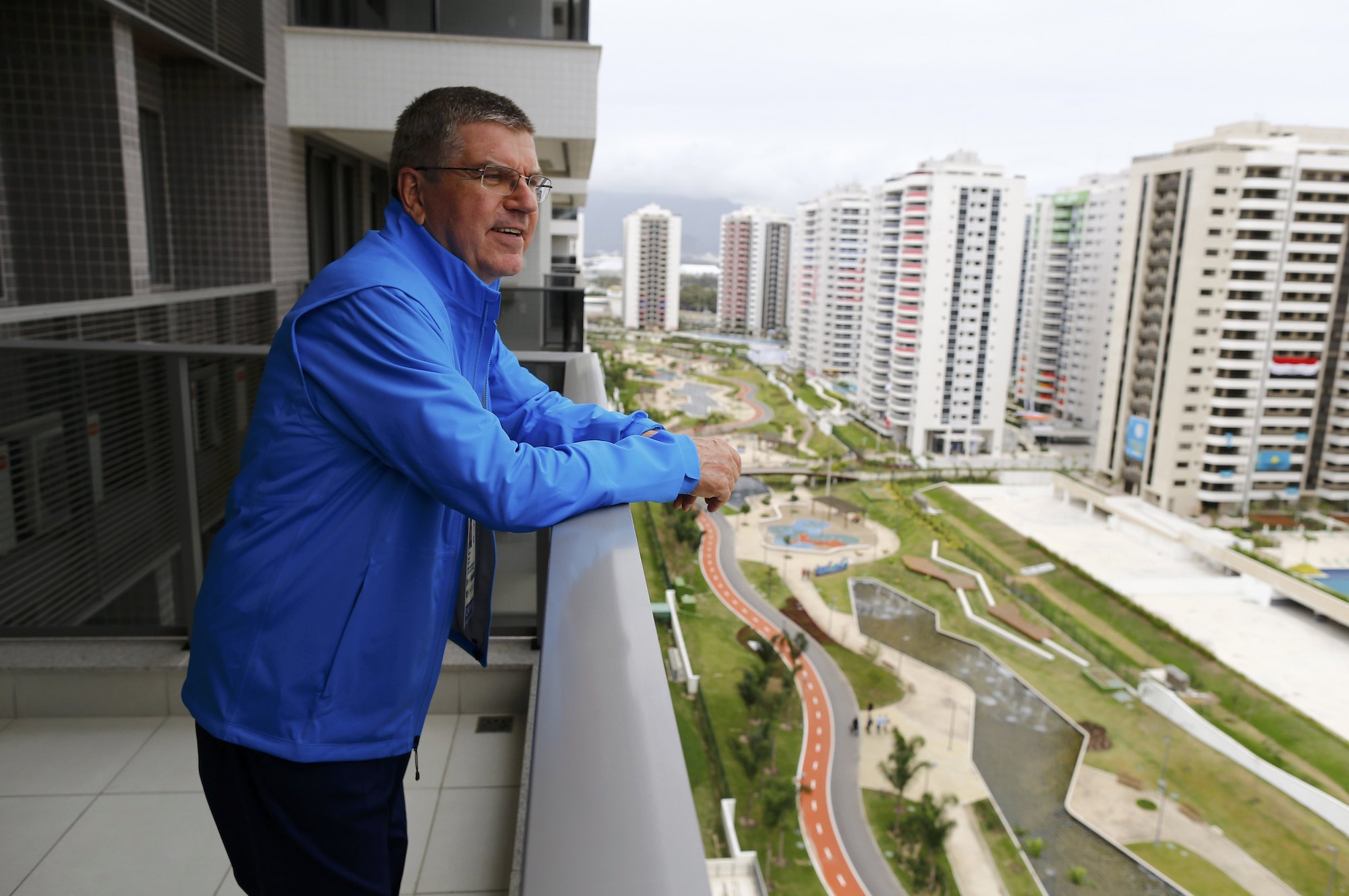 International Olympic Committee (IOC) President Thomas Bach looks from his balcony after moving into the Olympic village in Rio de Janeiro, Brazil, July 28, 2016. REUTERS/Ivan Alvarado TPX IMAGES OF THE DAY. FOR EDITORIAL USE ONLY. NOT FOR SALE FOR MARKETING OR ADVERTISING CAMPAIGNS.