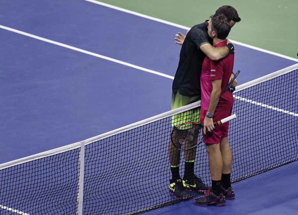Juan Martin del Potro, left, of Argentina, is embraced by Stan Wawrinka, of Switzerland, after a quarterfinal at the U.S. Open tennis tournament, early Thursday, Sept. 8, 2016, in New York. Wawrinka won 7-6 (5), 4-6, 6-3, 6-2. (AP Photo/Charles Krupa)