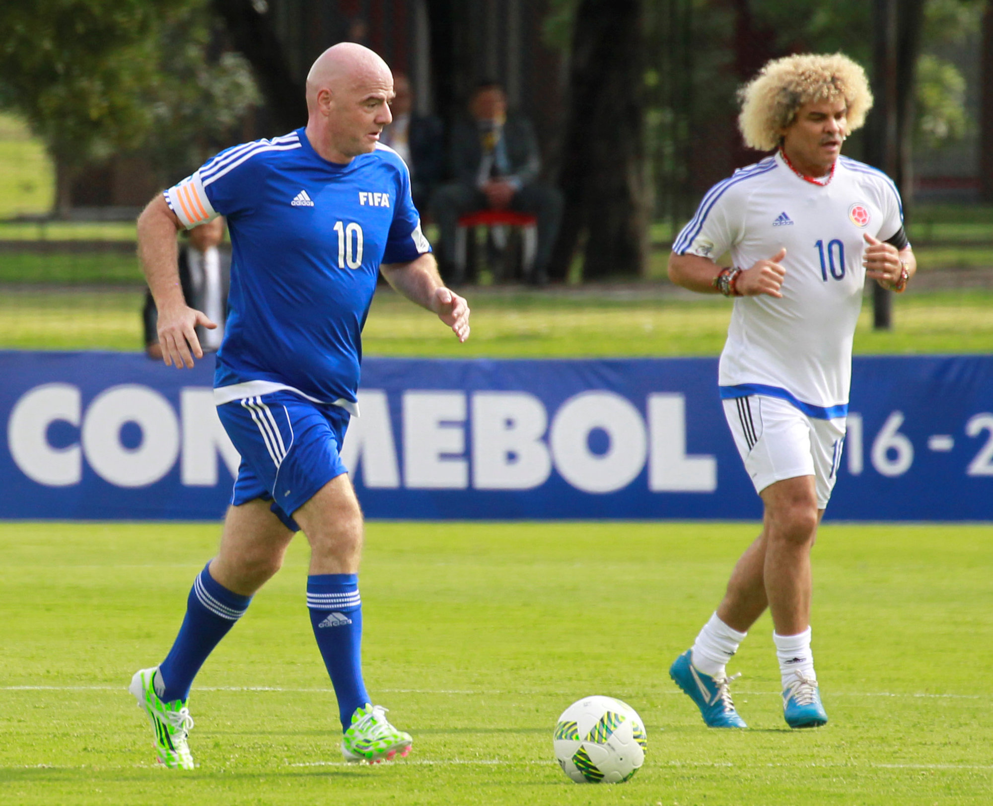 FIFA President Gianni Infantino goes for the ball next to Colombia's former soccer player Carlos Valderrama during a friendly soccer match in Bogota, Colombia, October 3, 2016. REUTERS/Felipe Caicedo FOR EDITORIAL USE ONLY. NO RESALES. NO ARCHIVES.