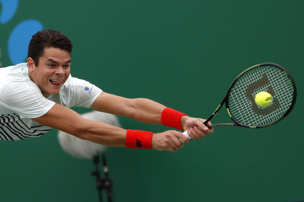 Milos Raonic of Canada hits a return shot against Pablo Lorenzi of Italy during the men's singles match of the Shanghai Masters tennis tournament at Qizhong Forest Sports City Tennis Center in Shanghai, China, Wednesday, Oct. 12, 2016. (AP Photo/Andy Wong)