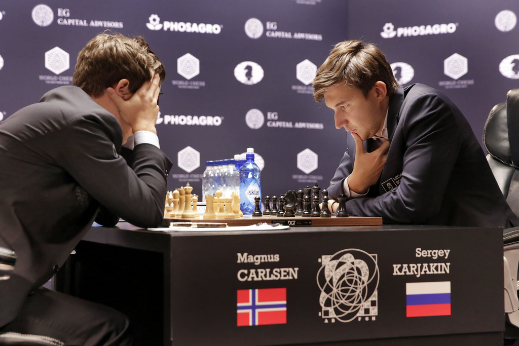 Magnus Carlsen, left, and Sergey Karjakin face off during round 8 of the World Chess Championship, in New York, Monday, Nov. 21, 2016. (AP Photo/Richard Drew)