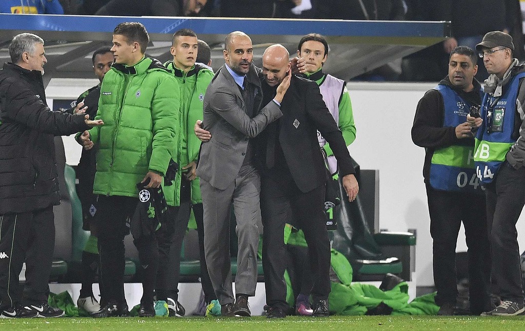 Manchester City's manager Pep Guardiola, centre, left, greets Moenchengladbach's head coach Andre Schubert after the Champions League Group C soccer match between Borussia Moenchengladbach and Manchester City in Moenchengladbach, Germany, Wednesday, Nov. 23, 2016. (AP Photo/Martin Meissner)