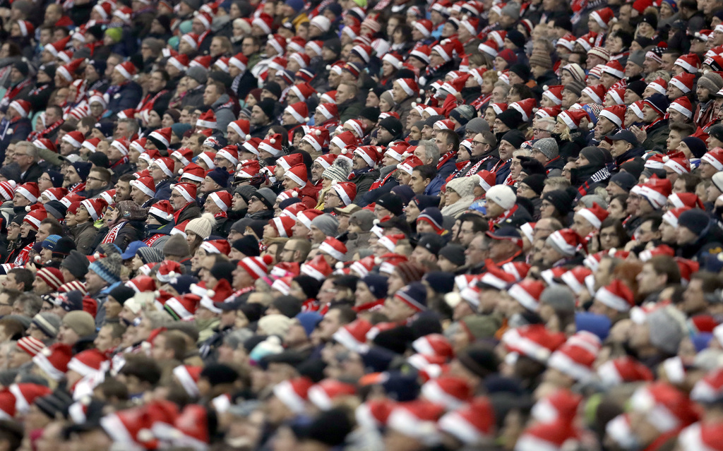 Supporters of Leipzig wear Santa Claus caps during the German Bundesliga soccer match between RB Leipzig and Hertha BSC Berlin in Leipzig, Germany, Saturday, Dec. 17, 2016. (AP Photo/Michael Sohn)