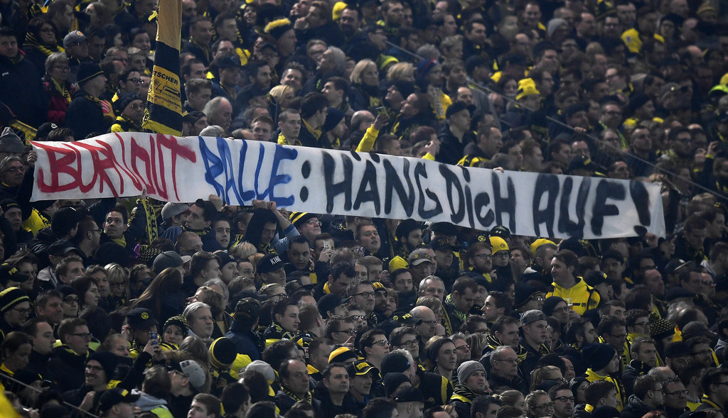 Dortmund supporters show a banner reading 'Burnout Ralle - hang yourself' against Leipzig sporting manager Ralf Rangnick prior the German Bundesliga soccer match between Borussia Dortmund and RB Leipzig in Dortmund, Saturday, Feb. 4, 2017. (AP Photo/Martin Meissner)