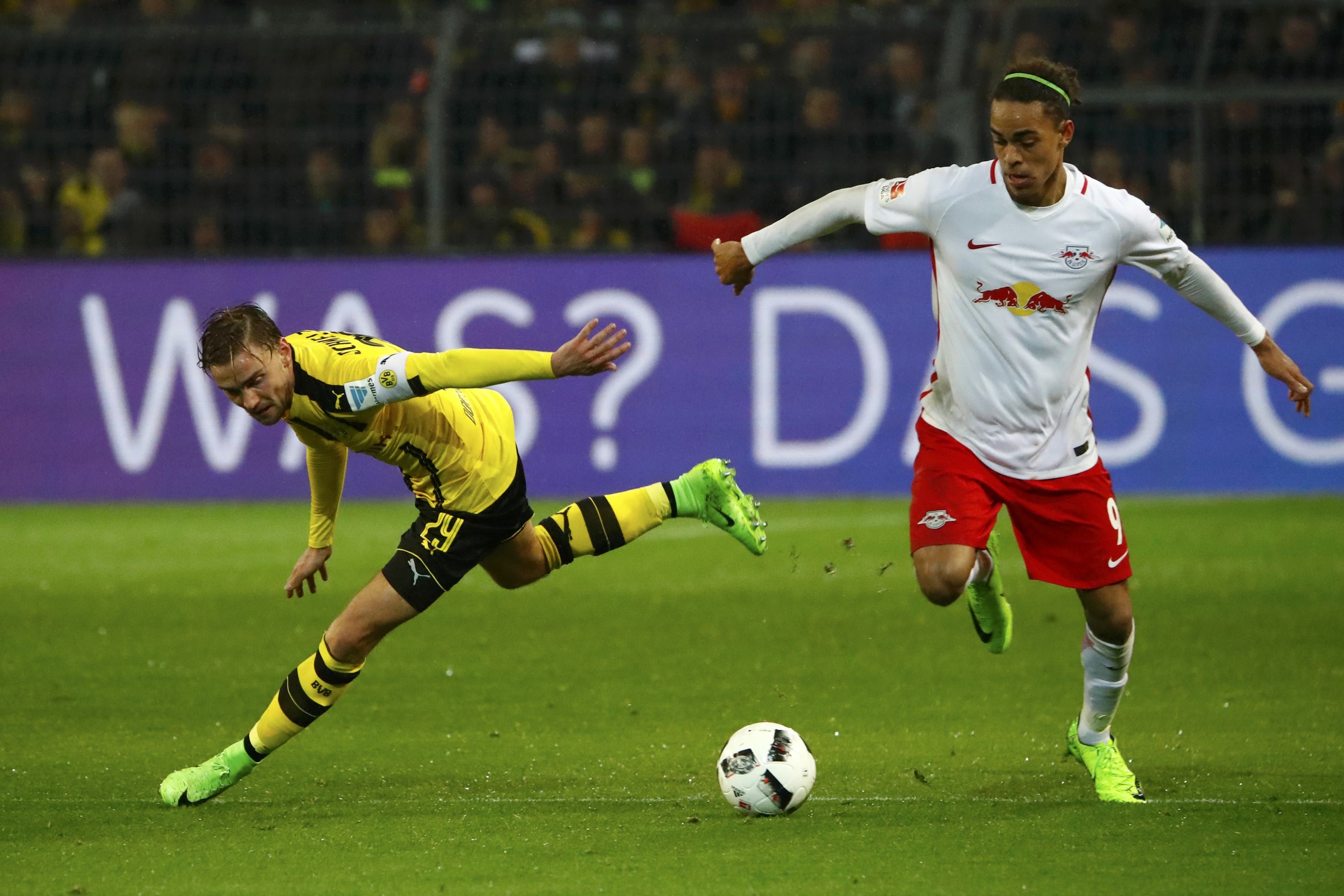 Football Soccer - Borussia Dortmund v RB Leipzig - German Bundesliga - Signal Iduna Park, Dortmund, Germany - 4/2/17 - Borussia Dortmund's Marcel Schmelzer in action with RB Leipzig's Yussuf Poulsen. REUTERS/Wolfgang Rattay DFL RULES TO LIMIT THE ONLINE USAGE DURING MATCH TIME TO 15 PICTURES PER GAME. IMAGE SEQUENCES TO SIMULATE VIDEO IS NOT ALLOWED AT ANY TIME. FOR FURTHER QUERIES PLEASE CONTACT DFL DIRECTLY AT + 49 69 650050.