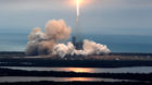 A SpaceX Falcon 9 rocket disappears into clouds after it lifted off on a supply mission to the International Space Station fr