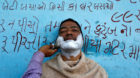 A man gets a shave from a roadside barber in Ahmedabad, India February 27, 2017.  REUTERS/Amit Dave  TPX IMAGES OF THE DAY
