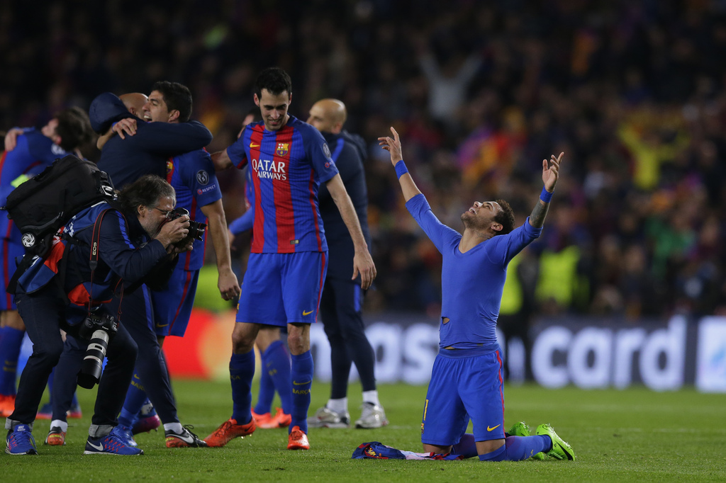 Barcelona's Neymar, right, celebrates with Barcelona's Sergio Busquets at the end of the Champions League round of 16, second leg soccer match between FC Barcelona and Paris Saint Germain at the Camp Nou stadium in Barcelona, Spain, Wednesday March 8, 2017. Barcelona won the match 6-1 (6-5 on aggregate). (AP Photo/Manu Fernandez)