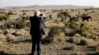 Britain's Foreign Secretary Boris Johnson uses his phone to take a picture of elephants at the Lewa wildlife conservancy spra