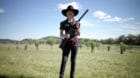 Jessica Healey, 12, under the character name 'Rosebud', poses with her rifle after competition at the Women of the West shoot