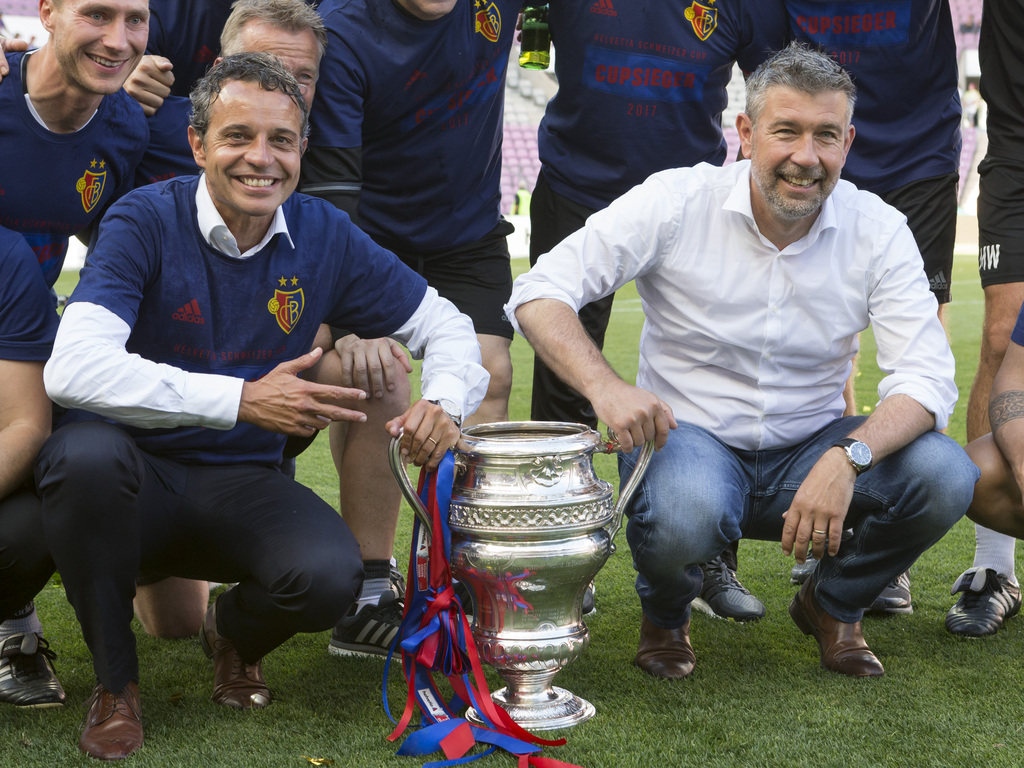 Basel's Praesident Bernhard Heusler, left, and head coach Urs Fischer, right, cheer with the trophy after winning the Swiss Cup final soccer match between FC Basel 1893 and FC Sion at the stade de Geneve stadium, in Geneva, Switzerland, on Thursday, May 25, 2017. (KEYSTONE/Salvatore Di Nolfi)
