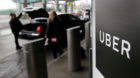 FILE - In this March 15, 2017, file photo, a sign marks a pick up point for the Uber car service at LaGuardia Airport in New 