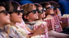 Group of children at the cinema watching a 3D movie