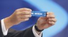 FIFA Secretary General Jerome Valcke holds up the slip showing "Switzerland" during the draw for the 2014 World Cup at the Co