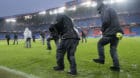 Staff members work under heavy rain to evacuate water from the field, prior the 2018 Fifa World Cup play-offs second leg socc