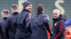 Manchester United's Zlatan Ibrahimovic, center, smiles with manager Jose Mourinho and teammates during a training session at 