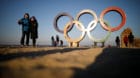 A couple poses for photographs next to the Olympic rings on a beach in Gangneung, South Korea February 3, 2018.  REUTERS/Kim 