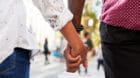 Close Up Of Couple Holding Hands On Urban Street