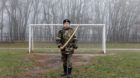 A cadet holds a model of a sword in front of a goalpost as he trains at the stadium of the General Yermolov Cadet School in S